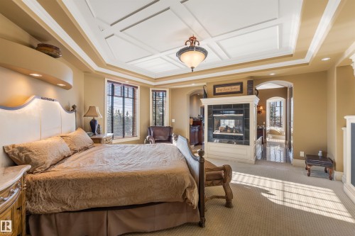 129 Riverview Crescent, Rural Sturgeon County, AB - Indoor Photo Showing Bedroom With Fireplace