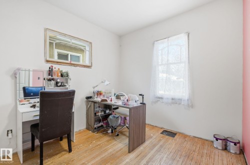 Office area featuring healthy amount of natural light and hardwood / wood-style floors - 11515 101 Street, Edmonton, AB - Indoor Photo Showing Office