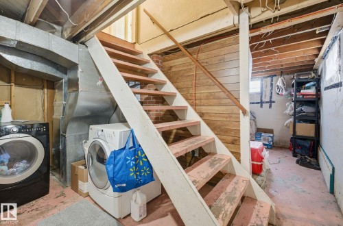 Unfinished basement with stairway, heating unit, and separate washer and dryer - 11515 101 Street, Edmonton, AB - Indoor Photo Showing Laundry Room