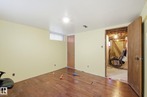 Unfurnished bedroom featuring hardwood / wood-style floors - 11515 101 Street, Edmonton, AB - Indoor Photo Showing Other Room