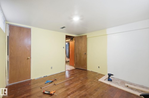 Unfurnished bedroom featuring hardwood / wood-style floors - 11515 101 Street, Edmonton, AB - Indoor Photo Showing Other Room