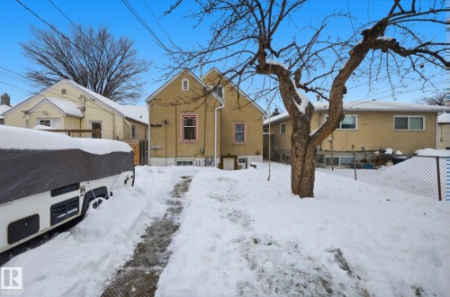 Snow covered back of property featuring stucco siding - 11515 101 Street, Edmonton, AB - Outdoor
