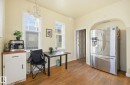 Office space featuring dark wood-style flooring and a chandelier - 11515 101 Street, Edmonton, AB  - Indoor 