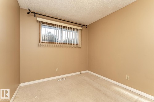 Carpeted spare room featuring a textured ceiling - 10207 165 Avenue, Edmonton, AB - Indoor Photo Showing Other Room