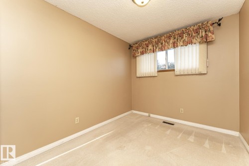 Carpeted empty room with baseboards and a textured ceiling - 10207 165 Avenue, Edmonton, AB - Indoor Photo Showing Other Room