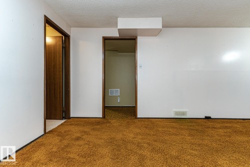Unfurnished bedroom featuring a textured ceiling and carpet - 10207 165 Avenue, Edmonton, AB - Indoor Photo Showing Other Room