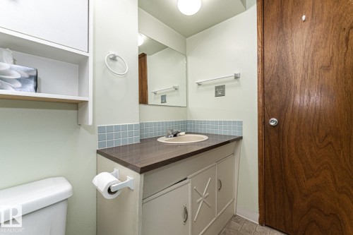 Half bathroom featuring vanity and backsplash - 10207 165 Avenue, Edmonton, AB - Indoor Photo Showing Bathroom