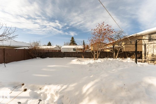 Yard layered in snow featuring a fenced backyard - 10207 165 Avenue, Edmonton, AB - Outdoor