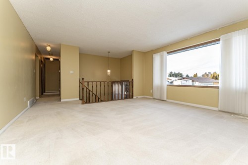 Empty room featuring a textured ceiling and light colored carpet - 10207 165 Avenue, Edmonton, AB - Indoor Photo Showing Other Room