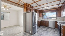 Kitchen featuring stainless steel appliances, tasteful backsplash, and dark brown cabinets - 