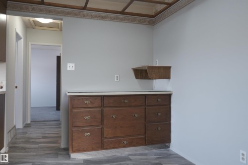 Kitchen featuring light countertops, dark wood finish cabinets, and dark wood-style flooring - 10478 21 Avenue, Edmonton, AB - Indoor Photo Showing Other Room