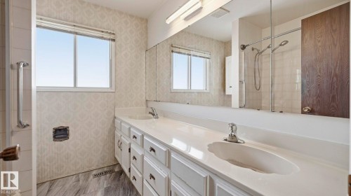 Bathroom with double vanity and wallpapered walls - 10478 21 Avenue, Edmonton, AB - Indoor Photo Showing Bathroom