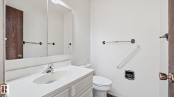 Half bath featuring vanity and toilet - 