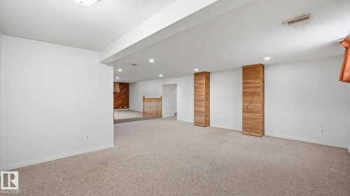 Basement featuring a textured ceiling, light colored carpet, and recessed lighting - 10478 21 Avenue, Edmonton, AB - Indoor