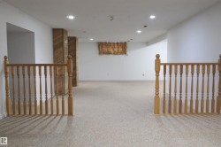 Hall featuring an upstairs landing, carpet flooring, and recessed lighting - 