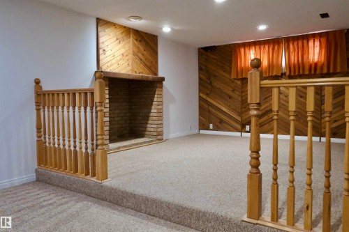 Staircase with wood walls, carpet flooring, and recessed lighting - 10478 21 Avenue, Edmonton, AB - Indoor Photo Showing Other Room