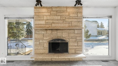 10478 21 Avenue, Edmonton, AB - Indoor Photo Showing Living Room With Fireplace
