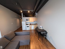 Living area featuring dark wood-style floors and track lighting - 