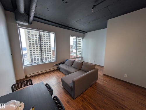 Living room with baseboard heating and wood finished floors - 1013 10024 Jasper Avenue, Edmonton, AB - Indoor Photo Showing Living Room