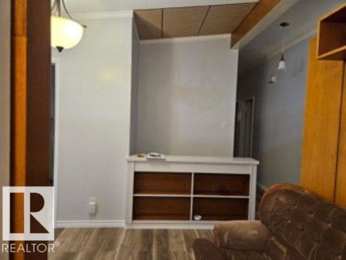 Living area with wood finished floors and baseboards - 4910 53 Avenue, Willingdon, AB 