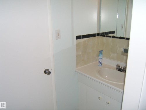Bathroom with vanity and decorative backsplash - 4910 53 Avenue, Willingdon, AB 