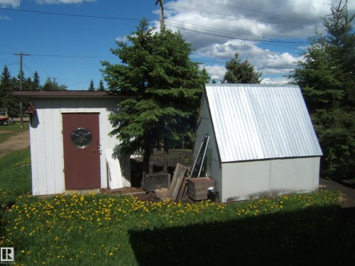 Two detached structures with solid paneling and a corrugated metal roof on the A-frame structure - 4910 53 Avenue, Willingdon, AB 