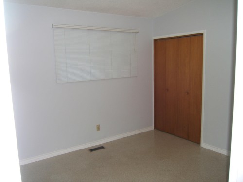 Unfurnished bedroom featuring a closet and speckled floor - 4910 53 Avenue, Willingdon, AB 