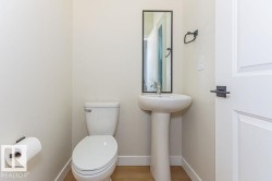 Bathroom with baseboards and wood finished floors - 