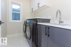 Laundry area with light marble finish floors, cabinet space, and independent washer and dryer - 