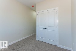 Unfurnished bedroom with light carpet and a closet - 