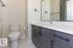 Full bathroom featuring vanity, light marble finish flooring, and a shower - 