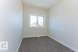 Unfurnished room featuring dark carpet and baseboards - 