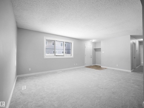 Unfurnished room featuring light colored carpet and a textured ceiling - 1460 Lakewood Road W, Edmonton, AB - Indoor Photo Showing Other Room