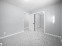 Unfurnished bedroom featuring carpet, a textured ceiling, and a closet - 