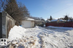 Yard layered in snow with a garage - 