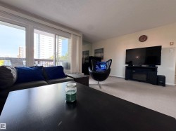 Carpeted living room with a textured ceiling and baseboards - 