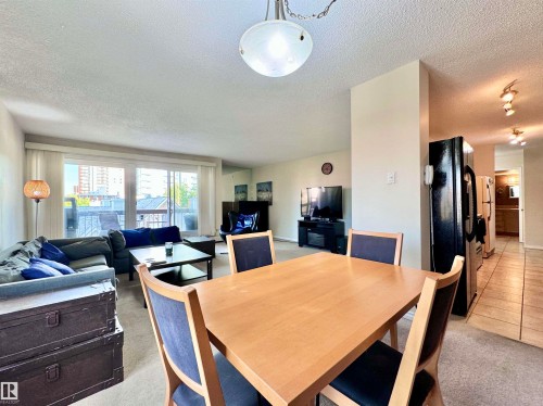 Dining area featuring light colored carpet and a textured ceiling - 503 9737 112 Street, Edmonton, AB - Indoor Photo Showing Dining Room