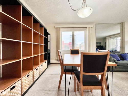 Dining space featuring light colored carpet, a textured ceiling, and a baseboard radiator - 503 9737 112 Street, Edmonton, AB - Indoor