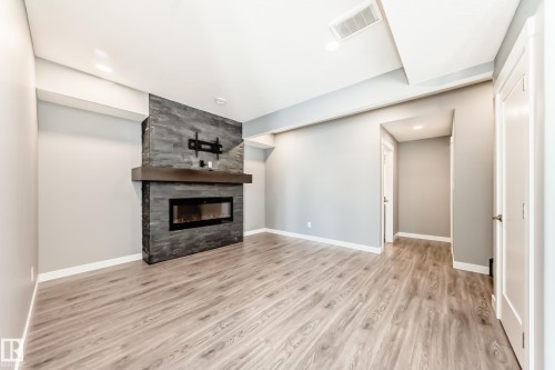 154 Aston Bend, Leduc, AB - Indoor Photo Showing Living Room With Fireplace