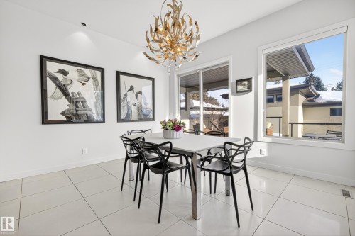 Dining area featuring light tile patterned floors and a chandelier - 9415 144 Street, Edmonton, AB - Indoor Photo Showing Dining Room
