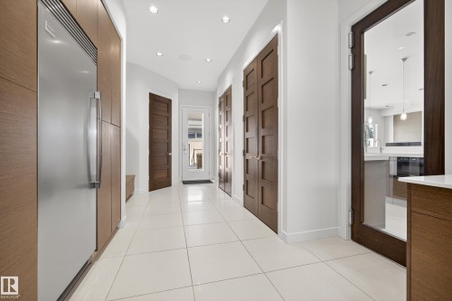 Corridor with light tile patterned floors and recessed lighting - 9415 144 Street, Edmonton, AB - Indoor Photo Showing Other Room