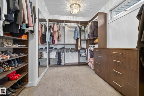 Spacious closet with light carpet and a chandelier - 9415 144 Street, Edmonton, AB - Indoor With Storage