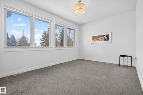 Carpeted spare room with baseboards - 9415 144 Street, Edmonton, AB - Indoor Photo Showing Other Room