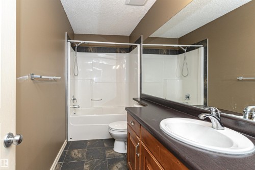 Full bathroom with vanity, shower / washtub combination, and a textured ceiling - 1612 Lacombe Crest, Edmonton, AB - Indoor Photo Showing Bathroom