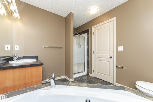 Full bathroom featuring vanity, a garden tub, a stall shower, and a textured ceiling - 1612 Lacombe Crest, Edmonton, AB - Indoor Photo Showing Bathroom