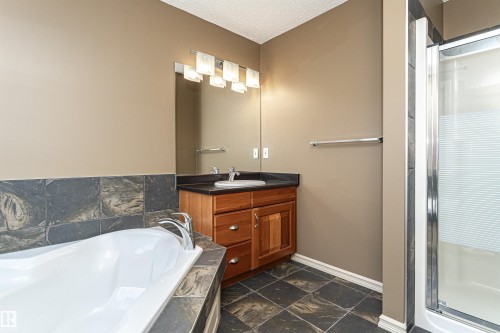 Full bath featuring vanity, a shower stall, a bath, and a textured ceiling - 1612 Lacombe Crest, Edmonton, AB - Indoor Photo Showing Bathroom