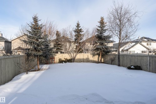 Yard covered in snow with a fenced backyard and a residential view - 1612 Lacombe Crest, Edmonton, AB - Outdoor