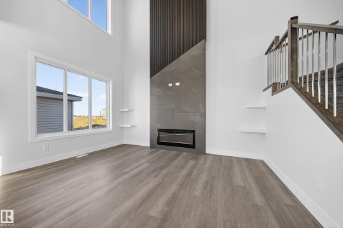 464 Crystal Creek Link, Leduc, AB - Indoor Photo Showing Other Room With Fireplace