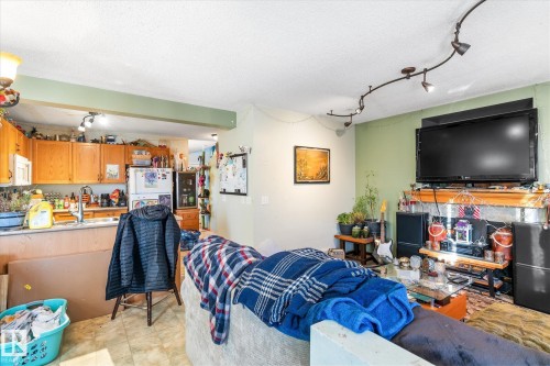Living room featuring a textured ceiling and track lighting - 15035 133 Street, Edmonton, AB - Indoor