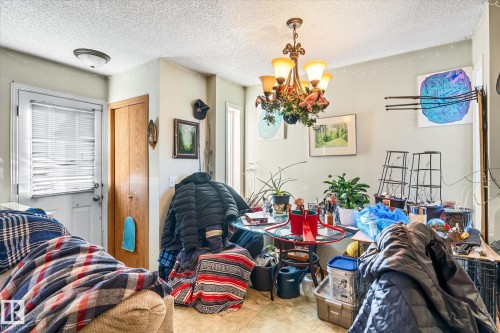 Dining room featuring a textured ceiling and a chandelier - 15035 133 Street, Edmonton, AB - Indoor